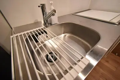 a stainless steel sink with a drain in it at \u6771\u99d2\u5f62202 in Tokyo