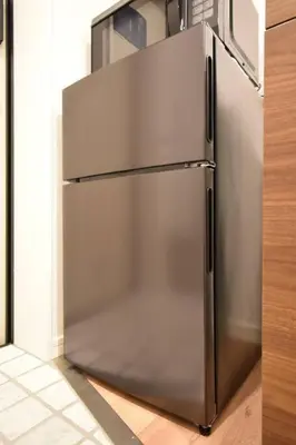 a stainless steel refrigerator sitting in a kitchen at \u6771\u99d2\u5f62202 in Tokyo