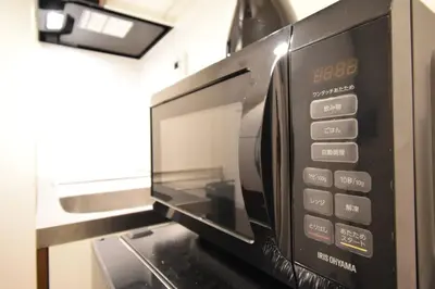 a microwave oven sitting on top of a counter at \u6771\u99d2\u5f62203 in Tokyo