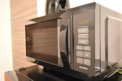 a microwave oven sitting on top of a counter at \u6771\u99d2\u5f62301 in Tokyo