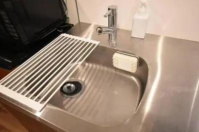 a metal sink with a toothbrush sitting on top of it at \u6771\u99d2\u5f62301 in Tokyo