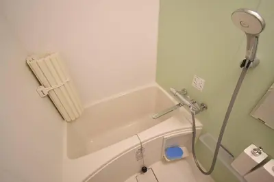 a bathroom with a bath tub with a shower at \u6771\u99d2\u5f62302 in Tokyo