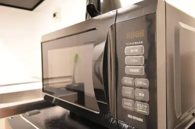 a microwave oven sitting on top of a counter at \u6771\u99d2\u5f62303 in Tokyo