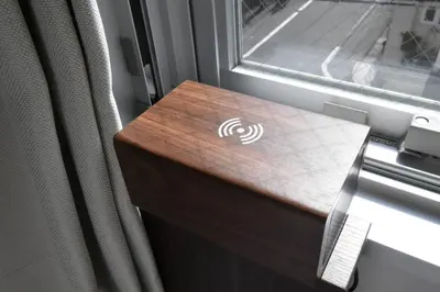 a wooden table next to a window on a train at \u6771\u99d2\u5f62303 in Tokyo