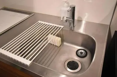 a metal sink with a piece of cheese at \u6771\u99d2\u5f62303 in Tokyo