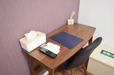 a desk with a computer and a box and a remote control at \u6771\u99d2\u5f62303 in Tokyo