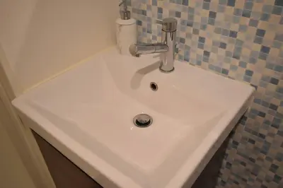 a white sink with a faucet in a bathroom at \u6771\u99d2\u5f62303 in Tokyo