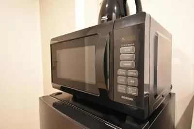 a microwave oven sitting on top of a table at \u6771\u99d2\u5f62401 in Tokyo