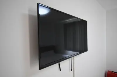 a flat screen tv hanging on a wall at \u6771\u99d2\u5f62401 in Tokyo