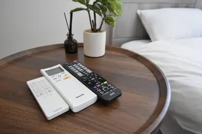 a wooden table with a remote control and a calculator at \u6771\u99d2\u5f62402 in Tokyo