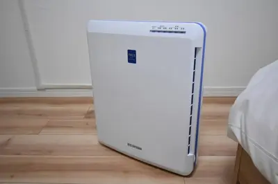 a white refrigerator sitting on a floor next to a bed at \u6771\u99d2\u5f62402 in Tokyo