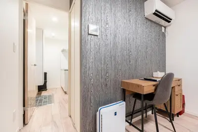 a room with a desk and a computer on a wall at \u6771\u99d2\u5f62403 in Tokyo