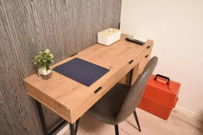 a wooden desk with a phone and a box on it at \u6771\u99d2\u5f62403 in Tokyo