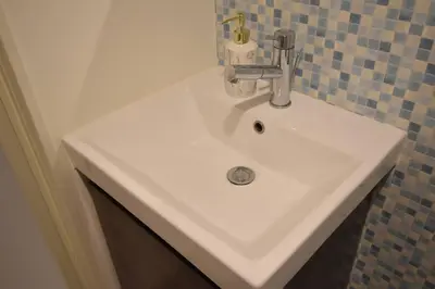 a white sink with a faucet in a bathroom at \u6771\u99d2\u5f62403 in Tokyo