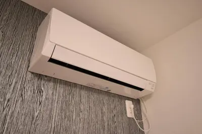 a white video game system sitting on the floor at \u6771\u99d2\u5f62403 in Tokyo