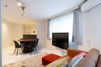 a living room with a couch and a table at Bonheur Akasaka in Tokyo