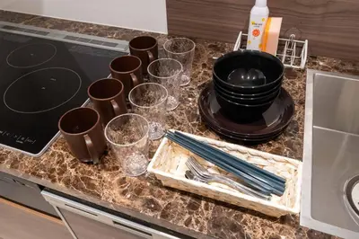 a kitchen counter with cups and utensils on it at Bonheur Akasaka in Tokyo