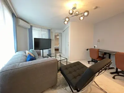 a living room with a couch and a table and a desk at Bonheur Akasaka in Tokyo