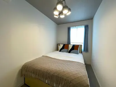a small bedroom with a bed with a window at Bonheur Akasaka in Tokyo