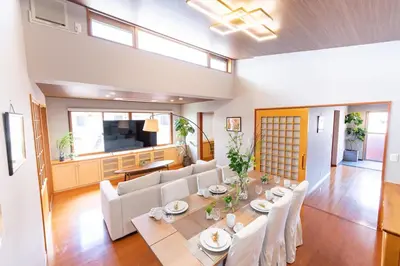 a dining room and living room with a table and chairs at SUA HOTEL Hikifune in Tokyo