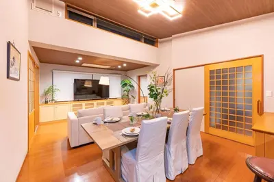a dining room and living room with a table and chairs at SUA HOTEL Hikifune in Tokyo
