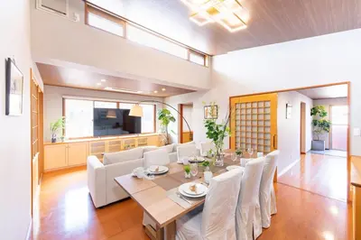 a dining room with a table and white chairs at SUA HOTEL Hikifune in Tokyo