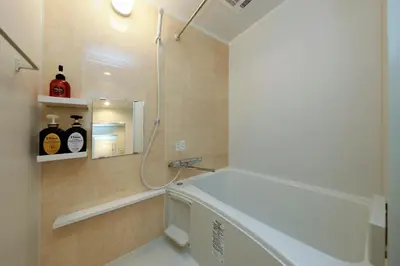 a bathroom with a shower and a bath tub at LIVION V Hatagaya by Tranova in Tokyo