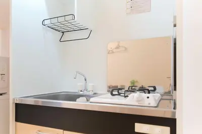 a kitchen with a sink and a mirror at Nakano Five by Tranova in Tokyo