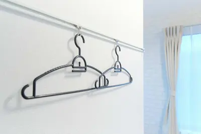 a metal towel rack in a bathroom next to a window at Nakano Five by Tranova in Tokyo