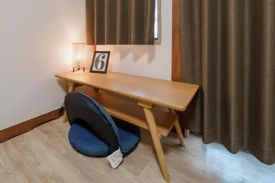 a wooden desk with a blue chair under it at Hidden Valley in Tokyo