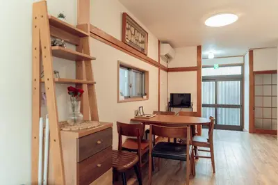 a kitchen and dining room with a table and chairs at Hidden Valley in Tokyo
