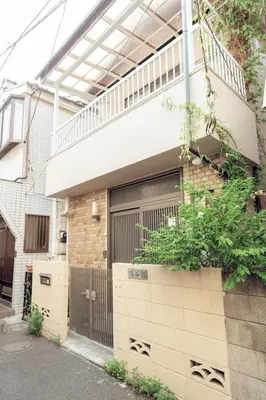 a house with a garage with a balcony on it at Hidden Valley in Tokyo