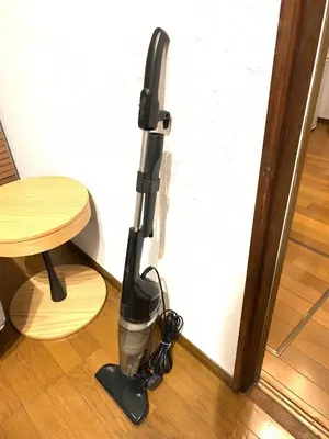 a black vacuum cleaner sitting next to a door at Takamatsu Guest House in Tokyo