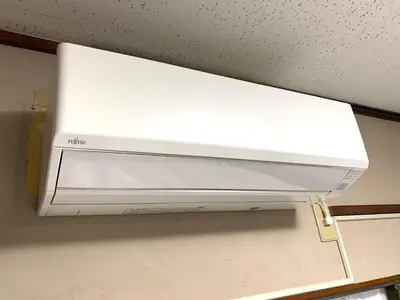 a white microwave oven hanging from the ceiling at Takamatsu Guest House in Tokyo