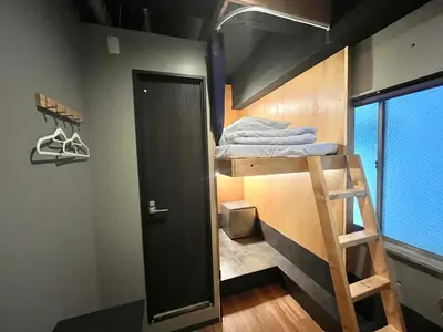 a room with a bunk bed with a ladder at Wasabi Mita Hotel in Tokyo