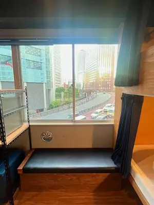 a window seat in a train with a view of a city at Wasabi Mita Hotel in Tokyo