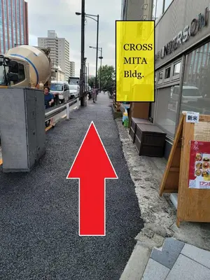 a red arrow on a street next to a building at Wasabi Mita Hotel in Tokyo