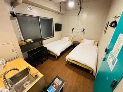 a hospital room with two beds and a sink at Wasabi Mita Hotel in Tokyo