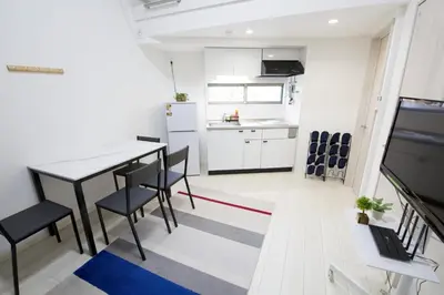 a kitchen and dining room with a table and chairs at Aries Nishi-Shinjuku 302 in Tokyo