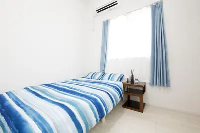 a bedroom with a bed and a window at Aries Nishi-Shinjuku 302 in Tokyo