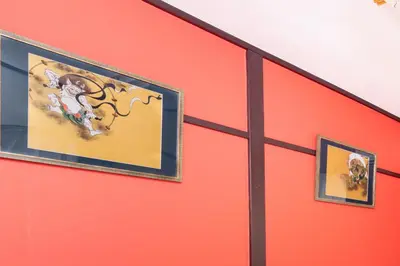two pictures on the side of a red wall at 6BR 10Beds Direct to Shinjuku, Shibuya ,Tokyo Dome, Central ,Budget Friendly in Tokyo