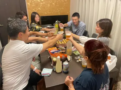 a group of people sitting around a table drinking beer at 6BR 10Beds Direct to Shinjuku, Shibuya ,Tokyo Dome, Central ,Budget Friendly in Tokyo