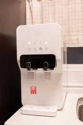 a white appliance sitting on top of a counter at 6BR 10Beds Direct to Shinjuku, Shibuya ,Tokyo Dome, Central ,Budget Friendly in Tokyo