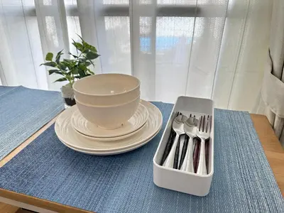 a bowl sitting on a table with a plate and a container at nestay apartment tokyo itabashi in Tokyo
