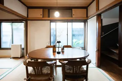 a dining room with a wooden table and chairs at 【70平米 長期予約大歓迎】6LDK/日本家屋貸切/大人数で寛げる空間 in Tokyo