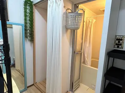 a door leading into a shower in a room at Backpackers' asakusa share house 