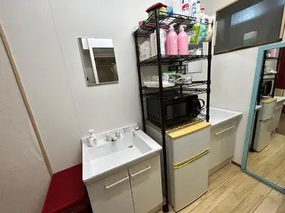 a small bathroom with a sink and a microwave at Backpackers' asakusa share house 