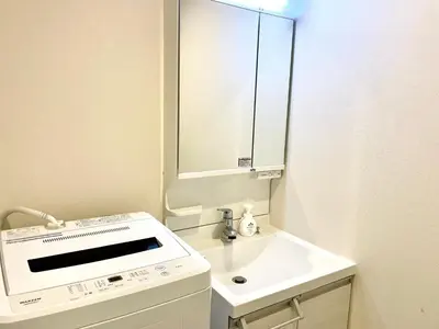 a white bathroom with a sink and a mirror at EveryNet Shinjuku by Tranova in Tokyo