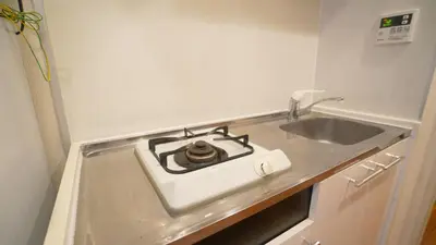 a kitchen counter with a stove and a sink at tokyo sky dream shinjuku in Tokyo