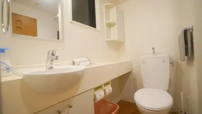 a white bathroom with a sink and a toilet at tokyo sky dream shinjuku in Tokyo